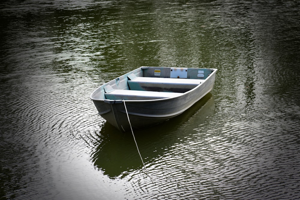 a small boat floating on top of a body of water