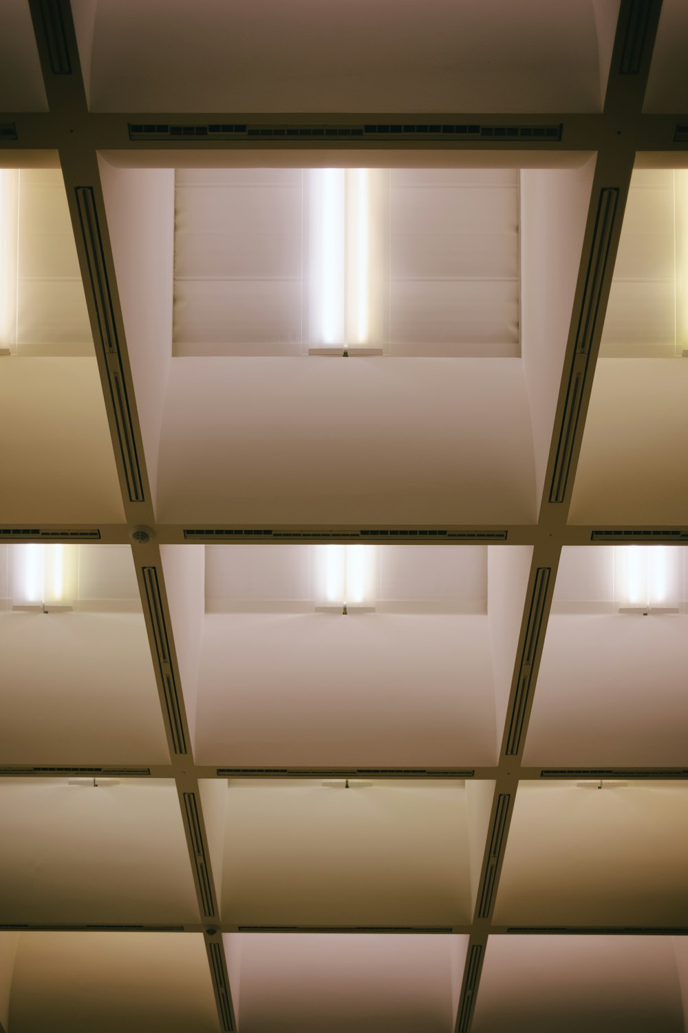 the ceiling of a building with lights in it