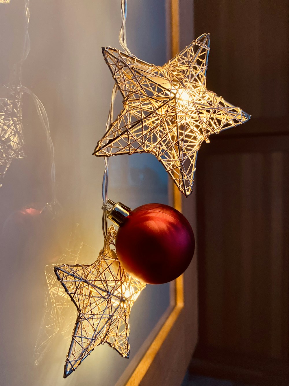 a christmas ornament hanging from a window