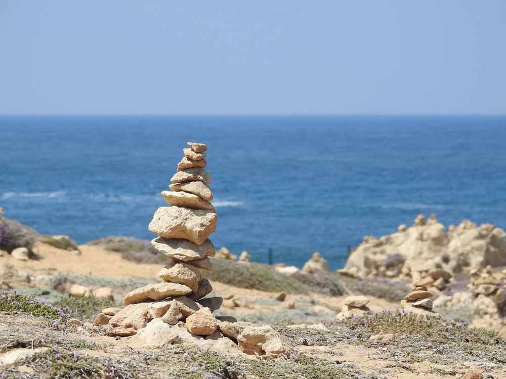 a stack of rocks sitting on top of a sandy beach