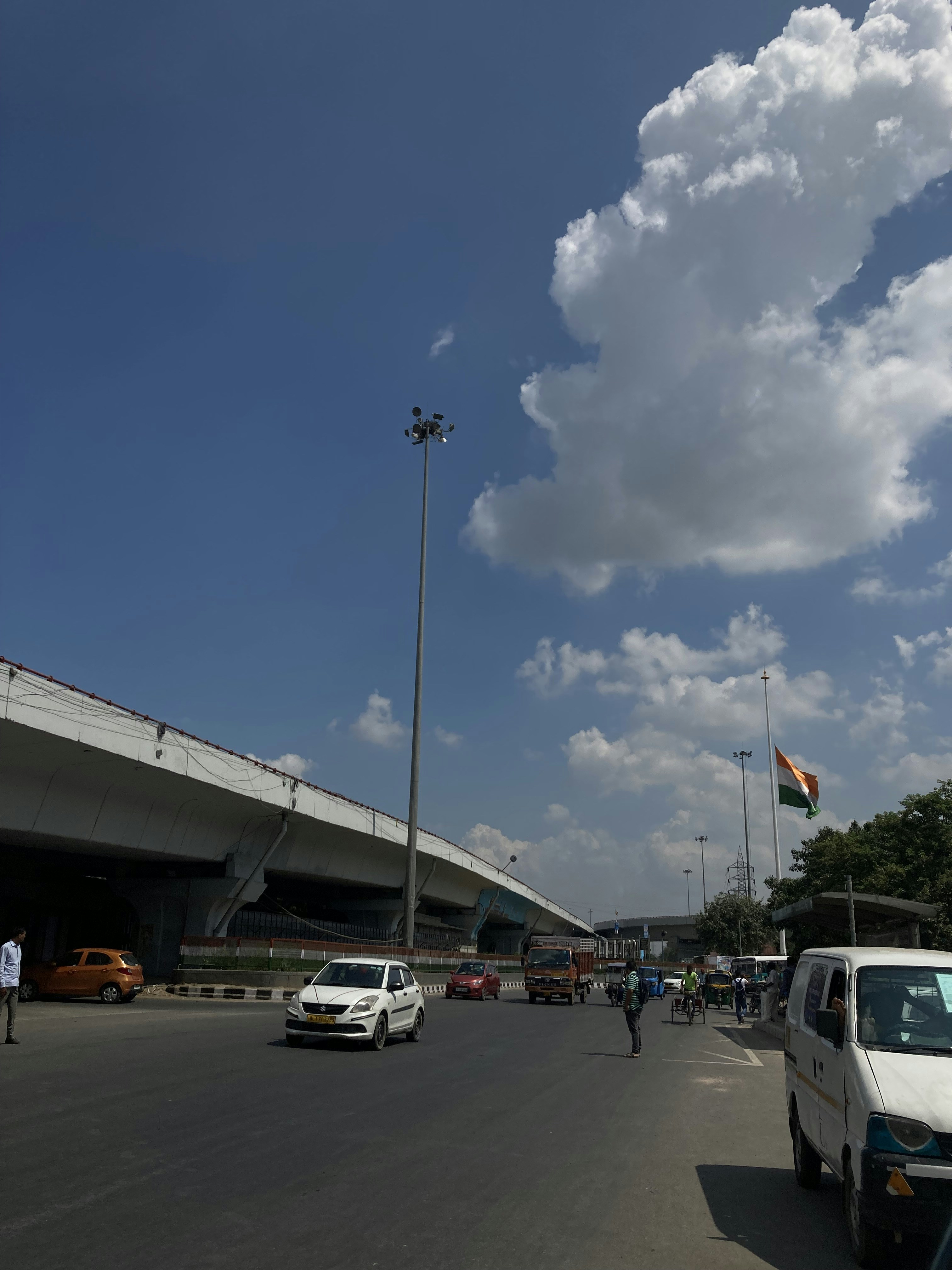a white van driving down a street next to a tall building