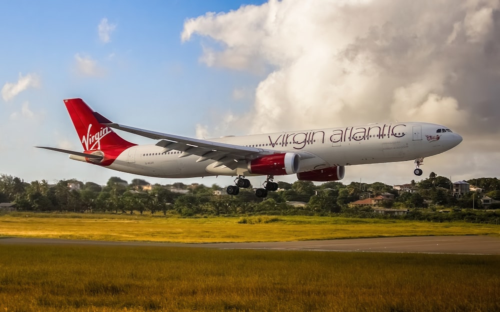 a virgin atlantic airplane taking off from an airport runway
