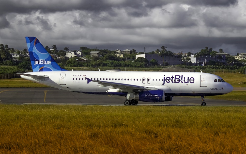 a jet blue airplane is on the runway