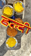 A bright and colorful Haldi ceremony setup adorned with marigold and jasmine flower garlands.