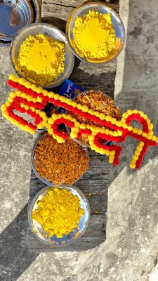 An assortment of ram tilak products arranged artistically against a warm, bhagwa-colored backdrop.
