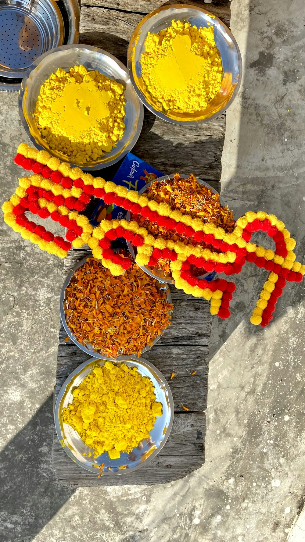 a wooden table topped with bowls of food