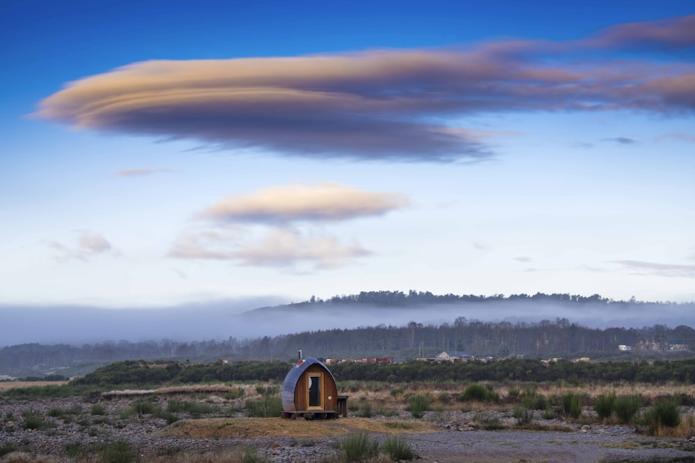 a small house in the middle of a field