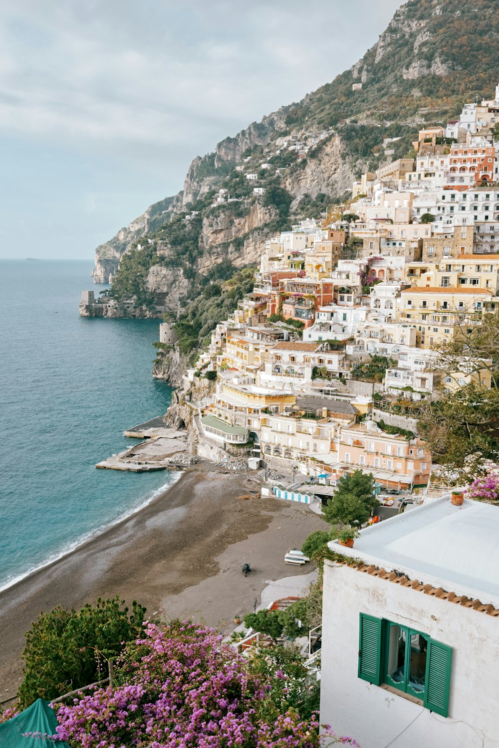 a view of a beach and a city from a hill