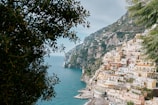 A scenic view of the Amalfi Coast with colorful houses perched on cliffs overlooking the sea.