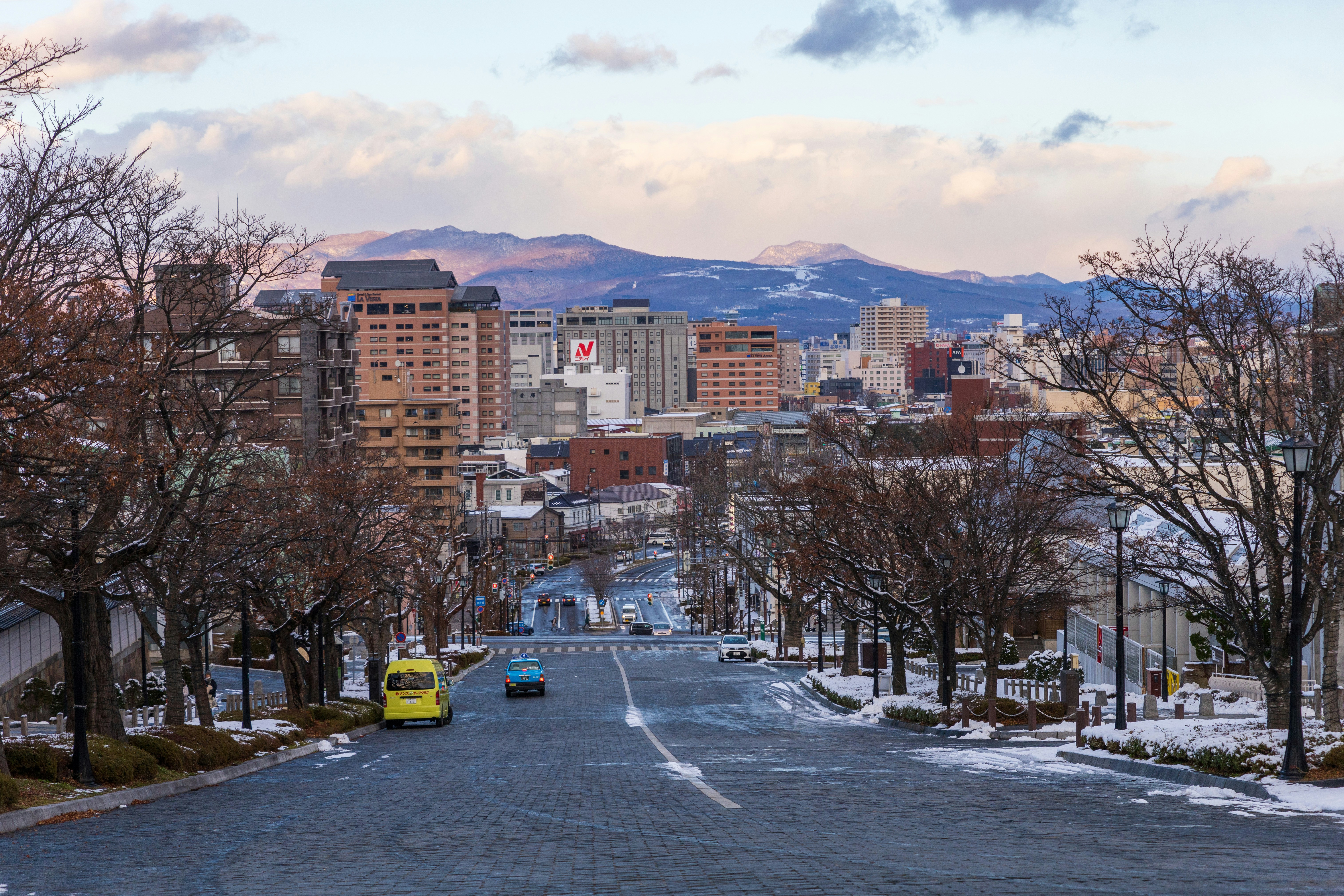 a view of a city street with snow on the ground