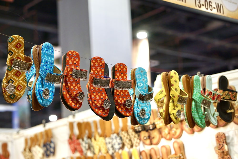 a display of colorful shoes hanging from a line