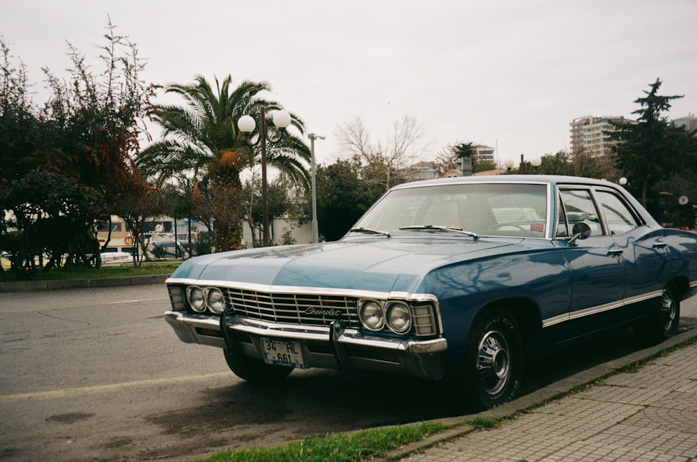 a blue car parked on the side of the road