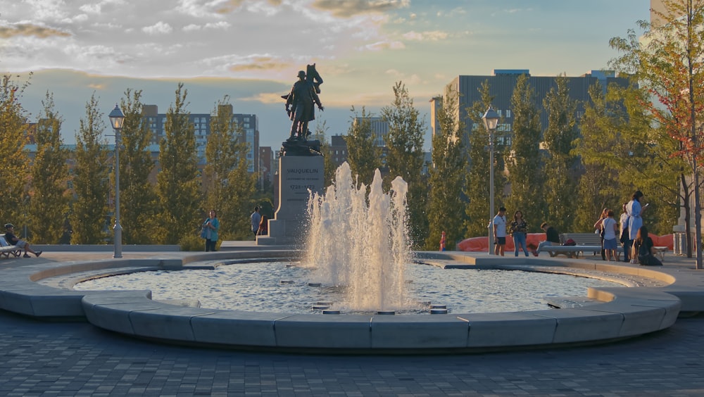 a fountain with a statue of a man on top of it