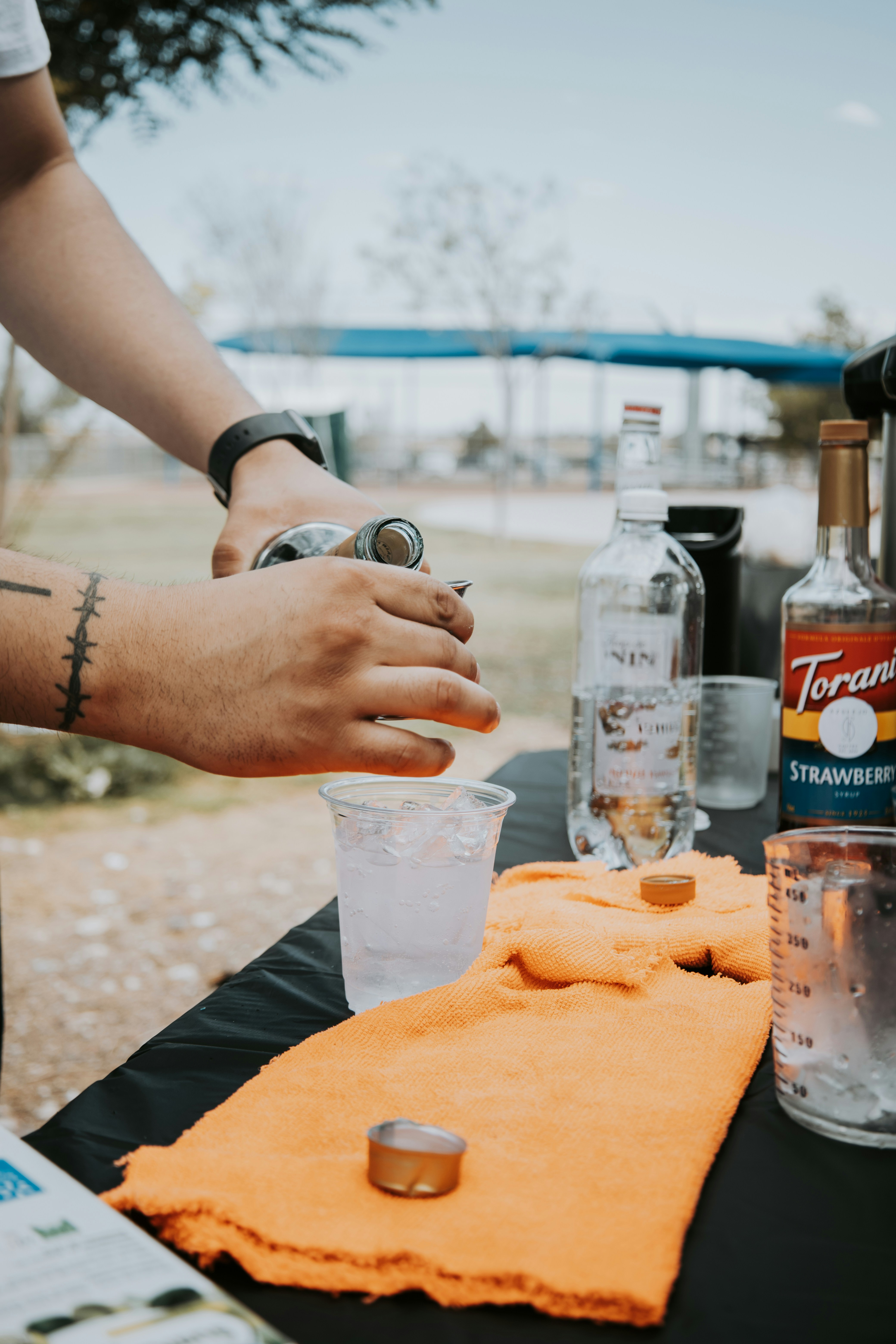 a person is making a drink at a table