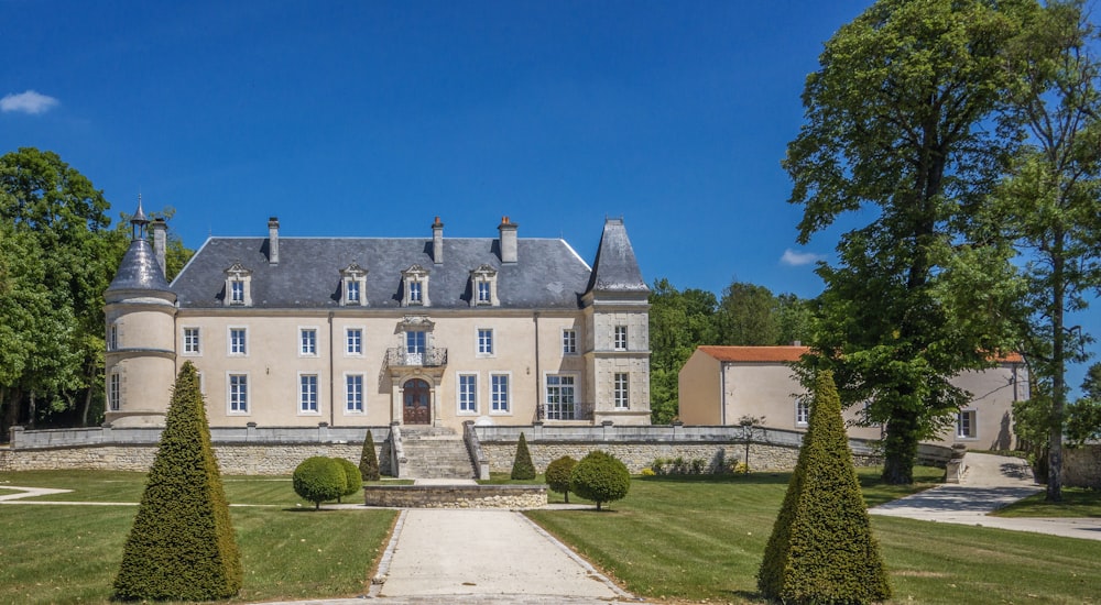 a large house with a lot of trees in front of it