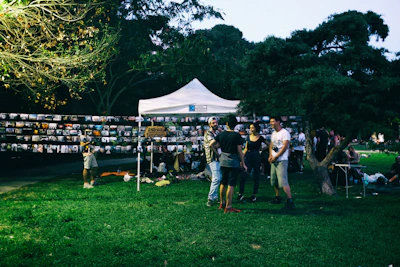 Volunteers collaborating at a community event setup in a local park.