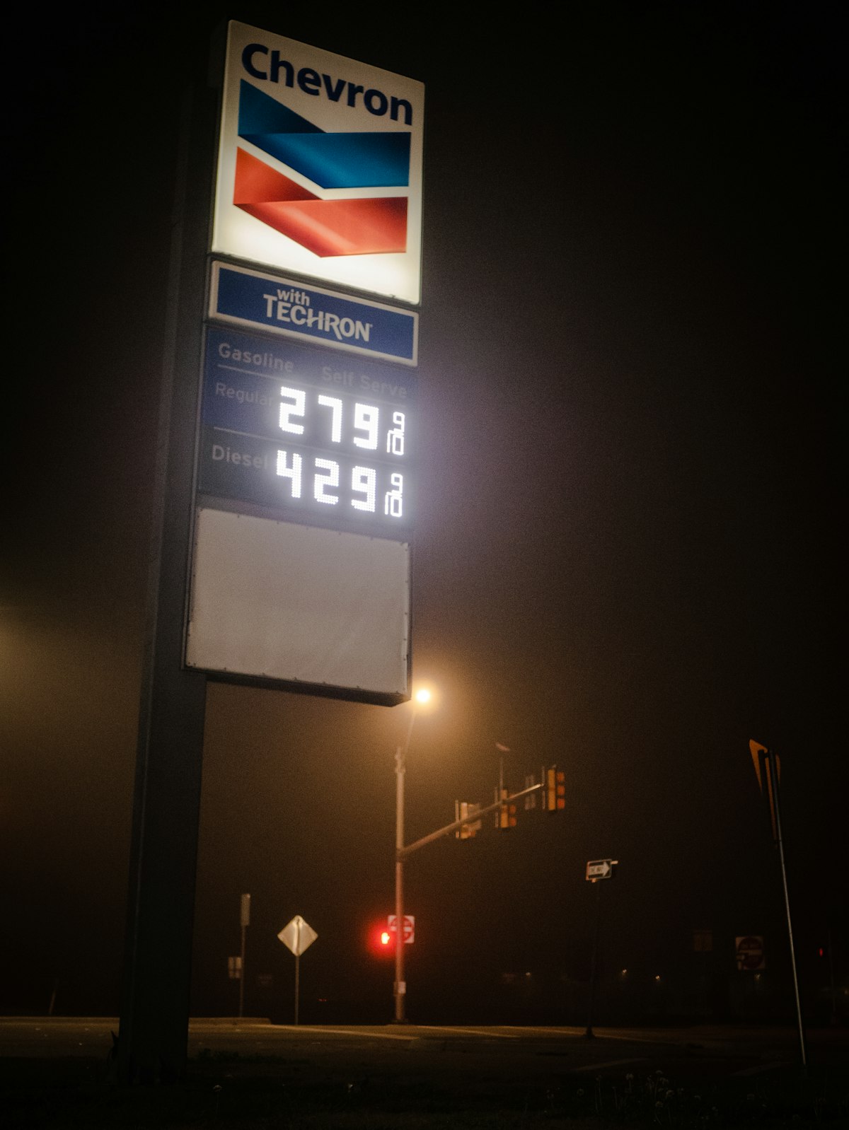Gas station price sign illuminated at night