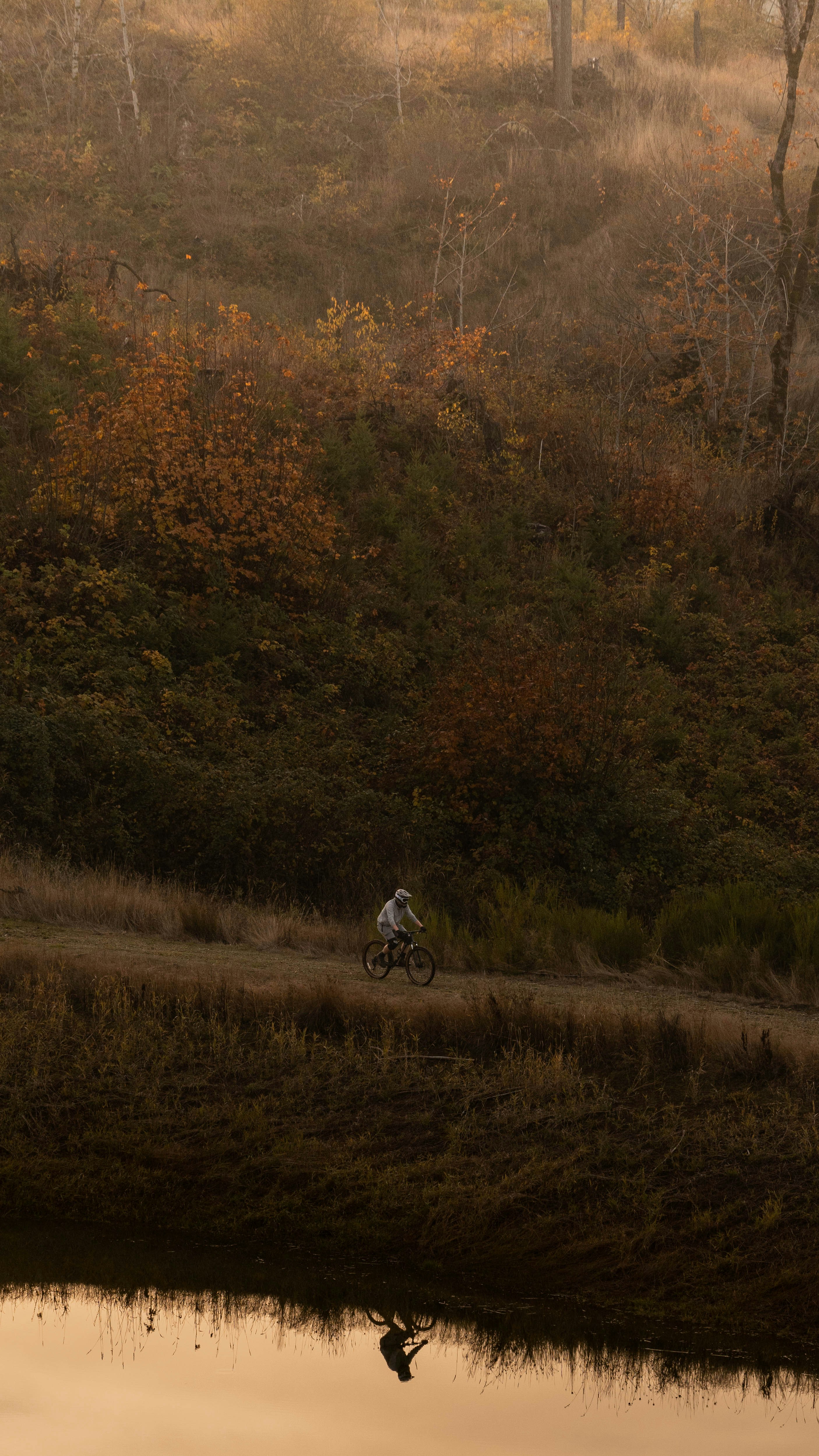 a man riding a bike down a dirt road