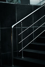 a black and white photo of a stair rail