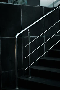a black and white photo of a stair rail