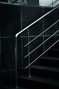 a black and white photo of a stair rail