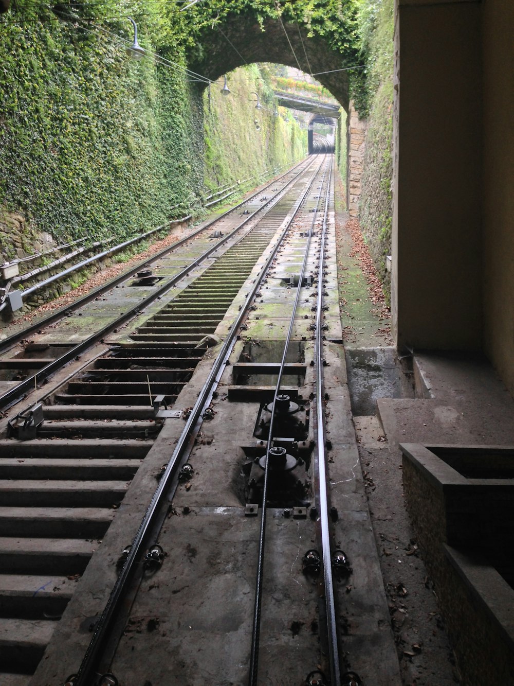 a train track with a tunnel in the middle of it