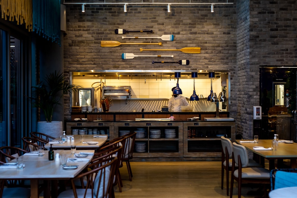 a restaurant with a brick wall and lots of tables