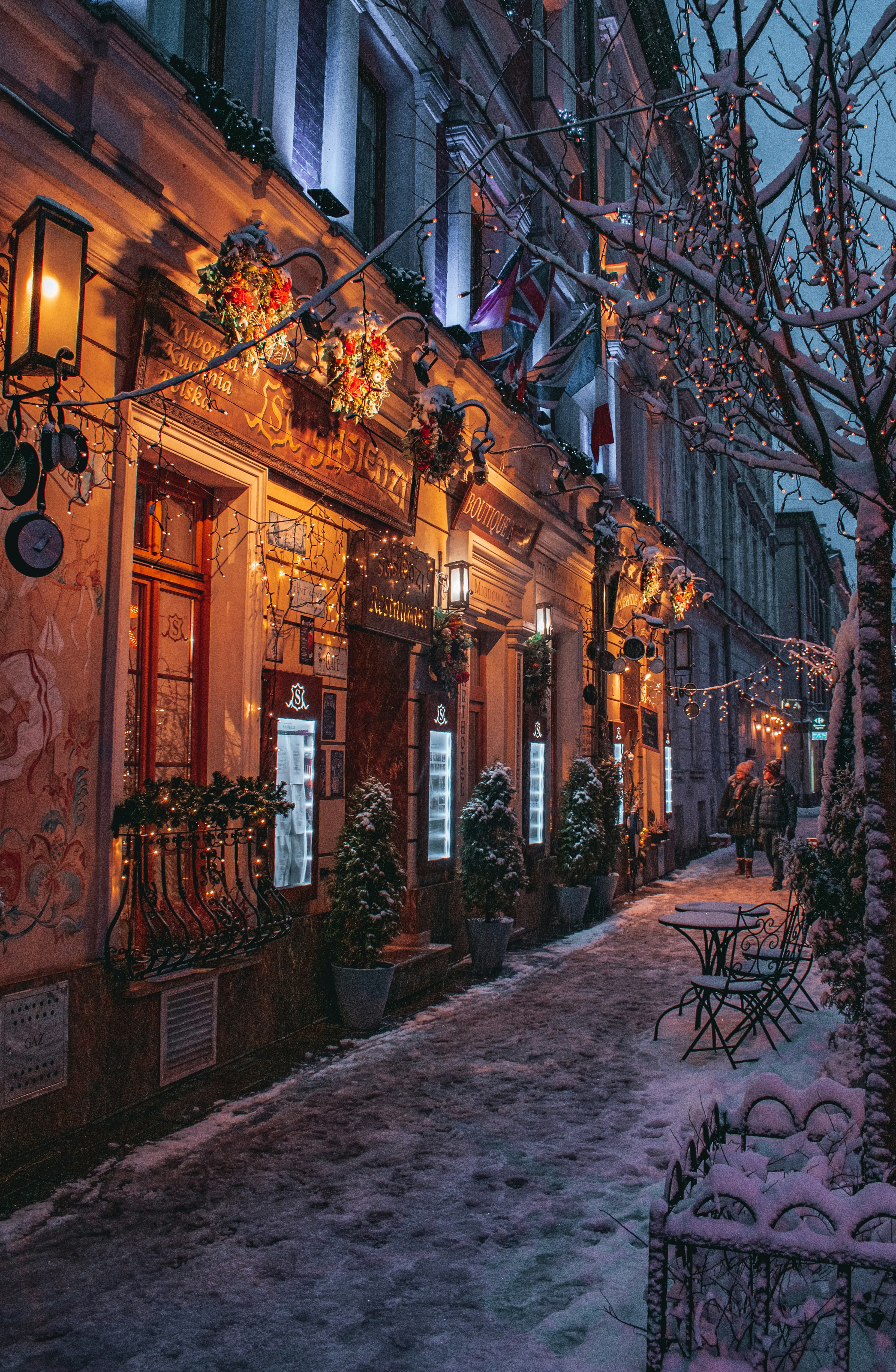 a snowy street lined with buildings and trees