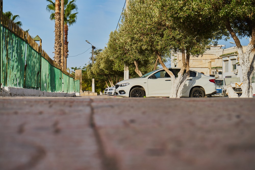 a white car parked on the side of the road