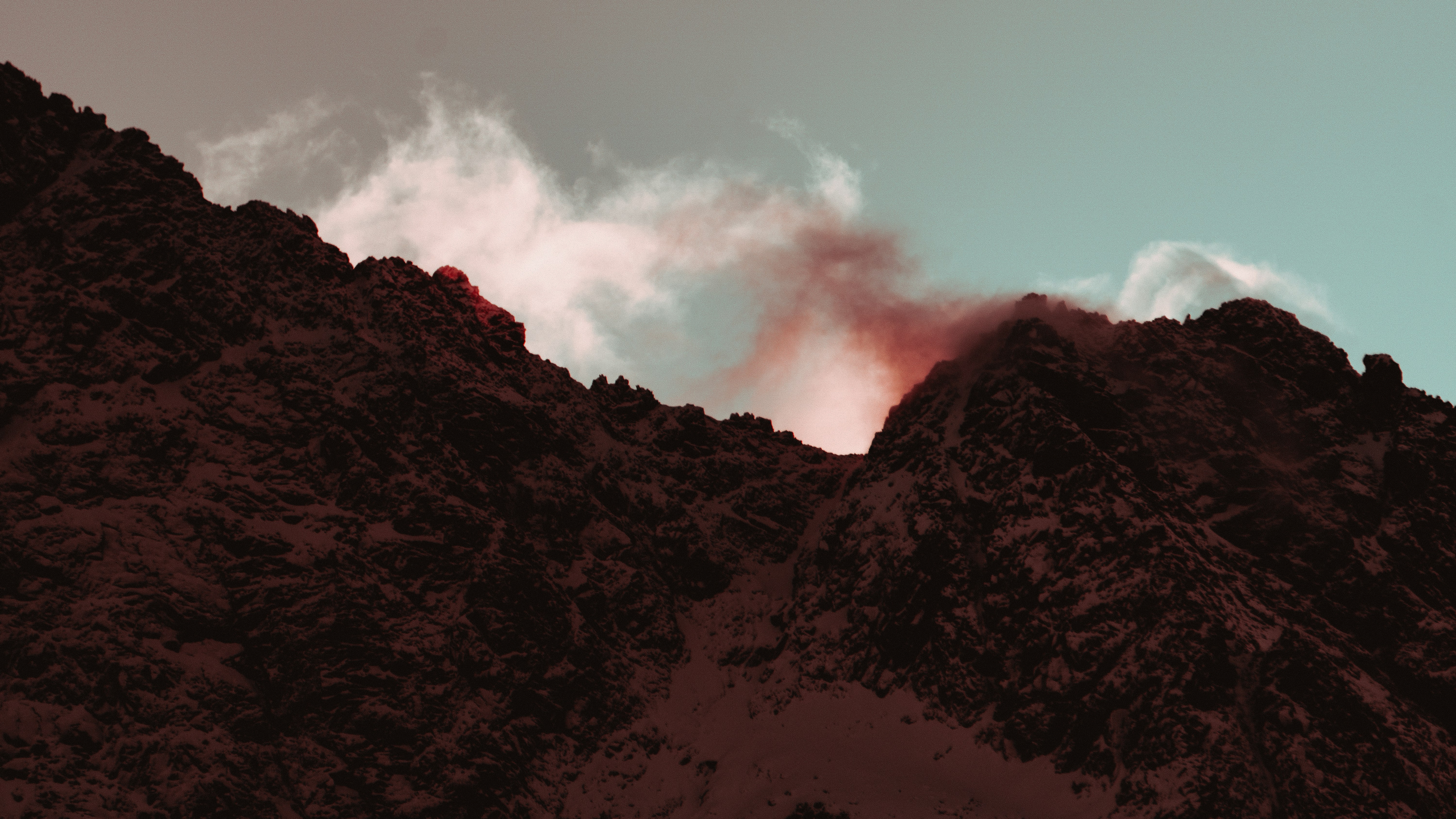 a very tall mountain with some clouds in the sky, 