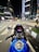 A dynamic urban scene featuring a motorcycle parked beside a vibrant cityscape, showcasing the thrill of adventure and urban exploration.