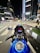 A dynamic urban scene featuring a motorcycle parked beside a vibrant cityscape, showcasing the thrill of adventure and urban exploration.