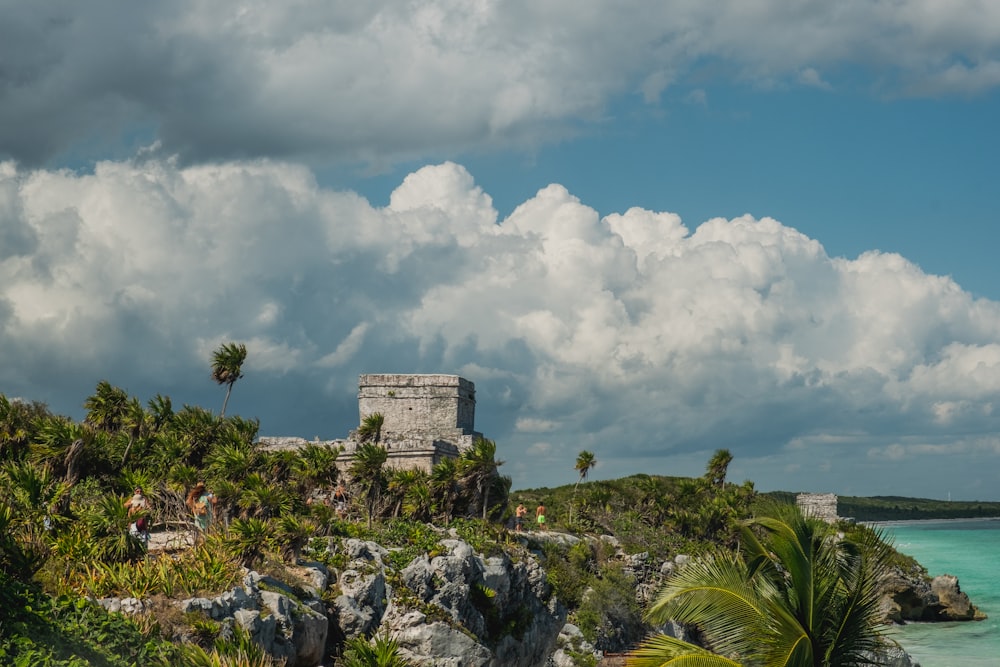 a view of the ruins of a castle on a tropical island