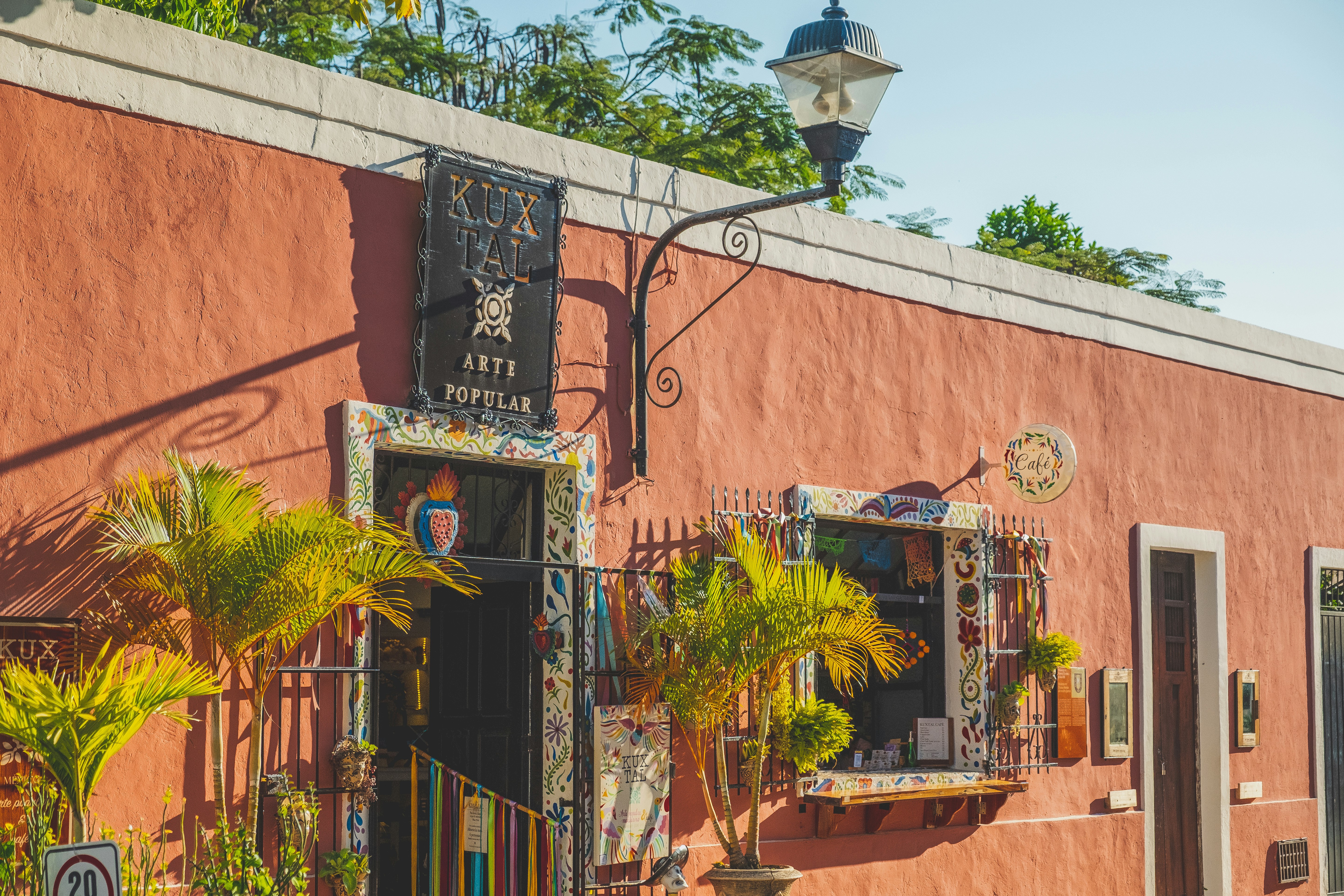 a pink building with a sign on the outside of it