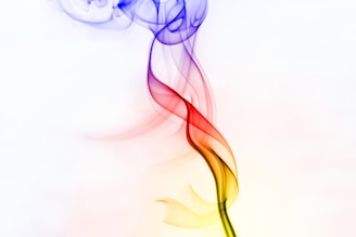 a red, yellow and blue smoke is in the air