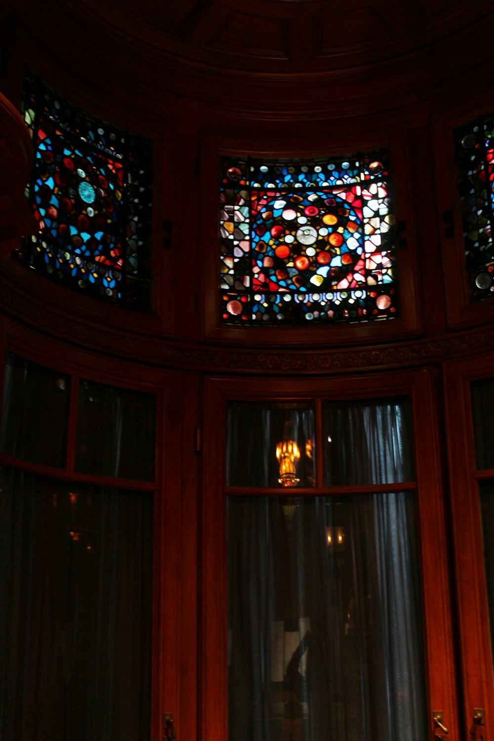 a room with a round window and stained glass