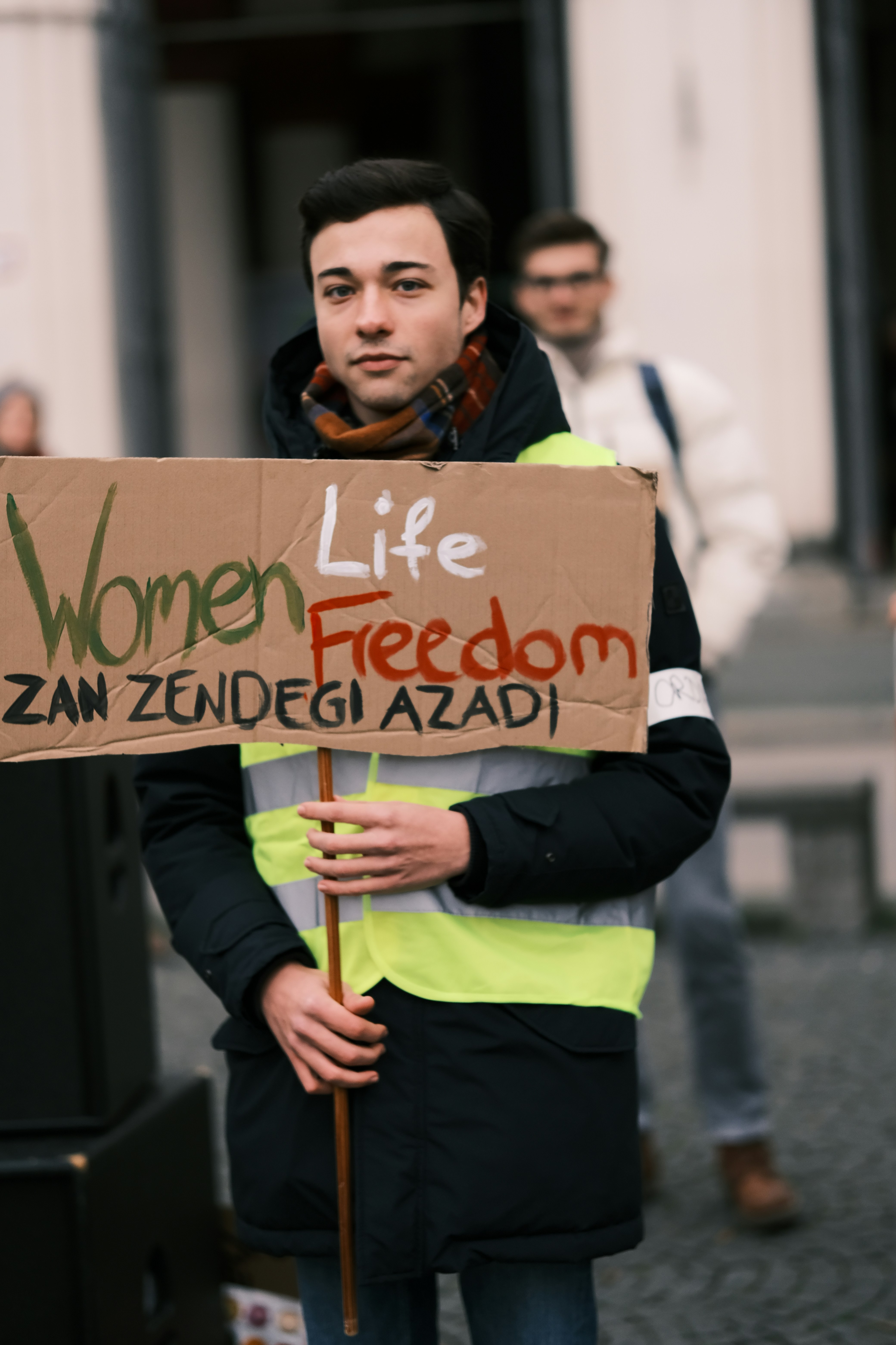 a man holding a sign that says women life