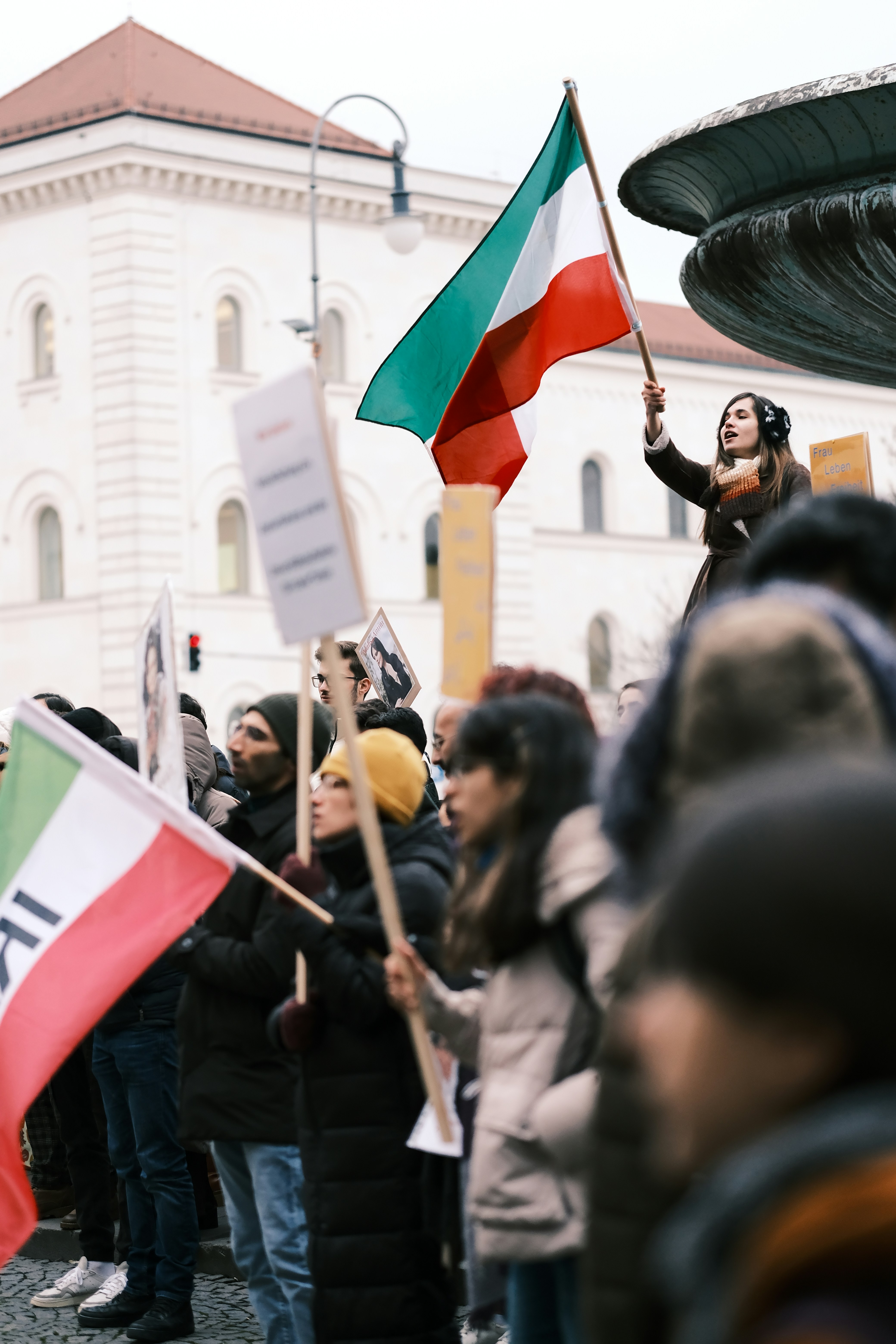 a group of people holding flags in front of a building