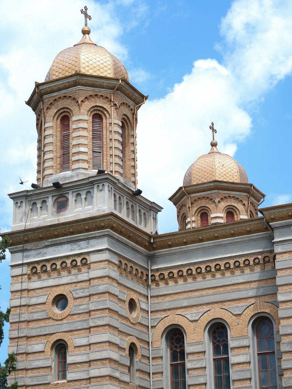 a large building with two towers and a cross on top