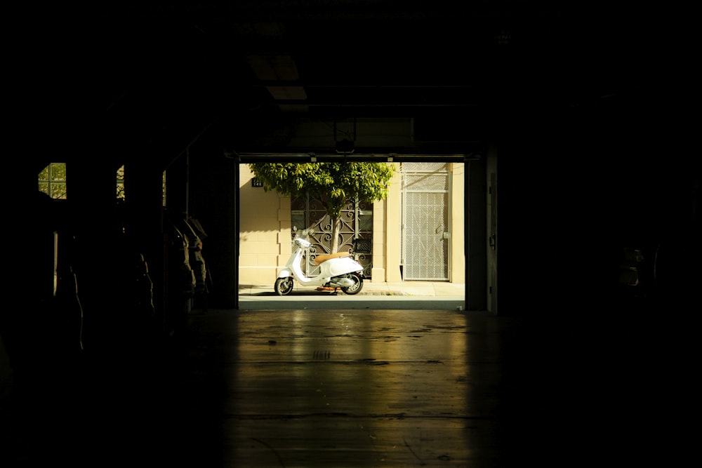 a scooter is parked in a dark garage