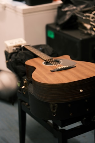 a guitar sitting on a chair in a room