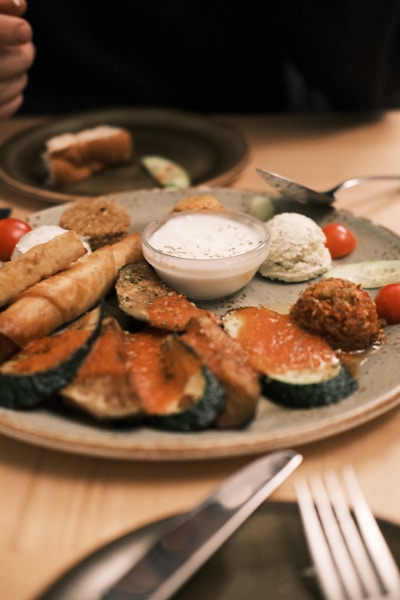 a plate of food on a table with a knife and fork