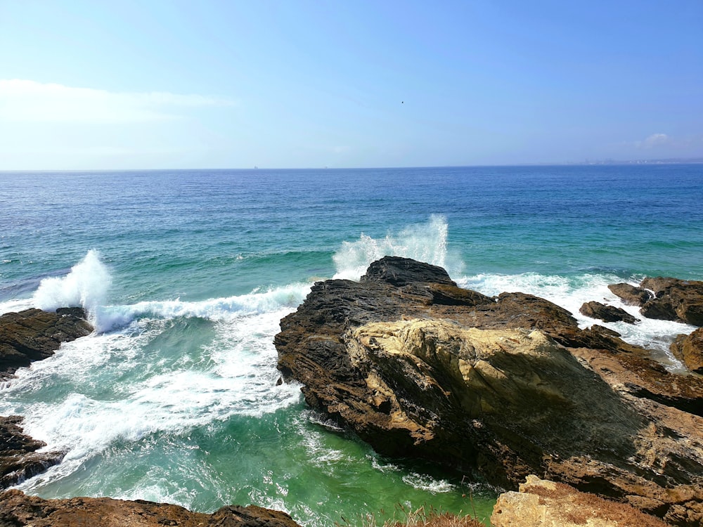 a view of the ocean from a rocky cliff