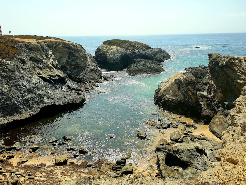 a body of water surrounded by large rocks