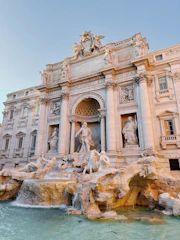 a large building with a fountain in front of it