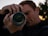 A focused photographer adjusting his camera lens during a vibrant outdoor shoot.