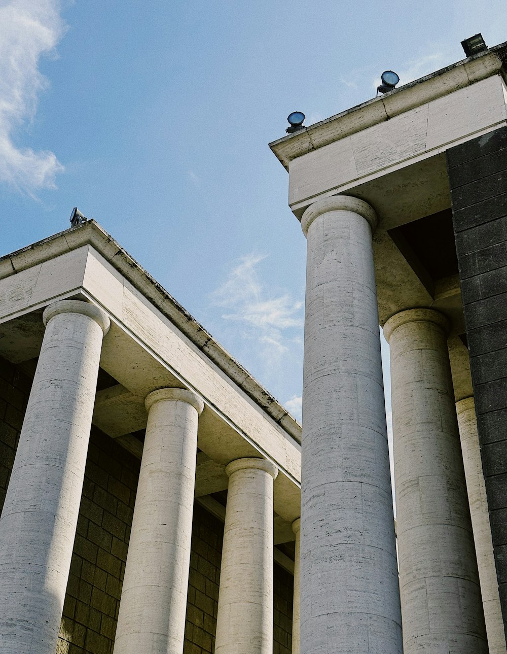 a couple of tall white pillars sitting next to each other