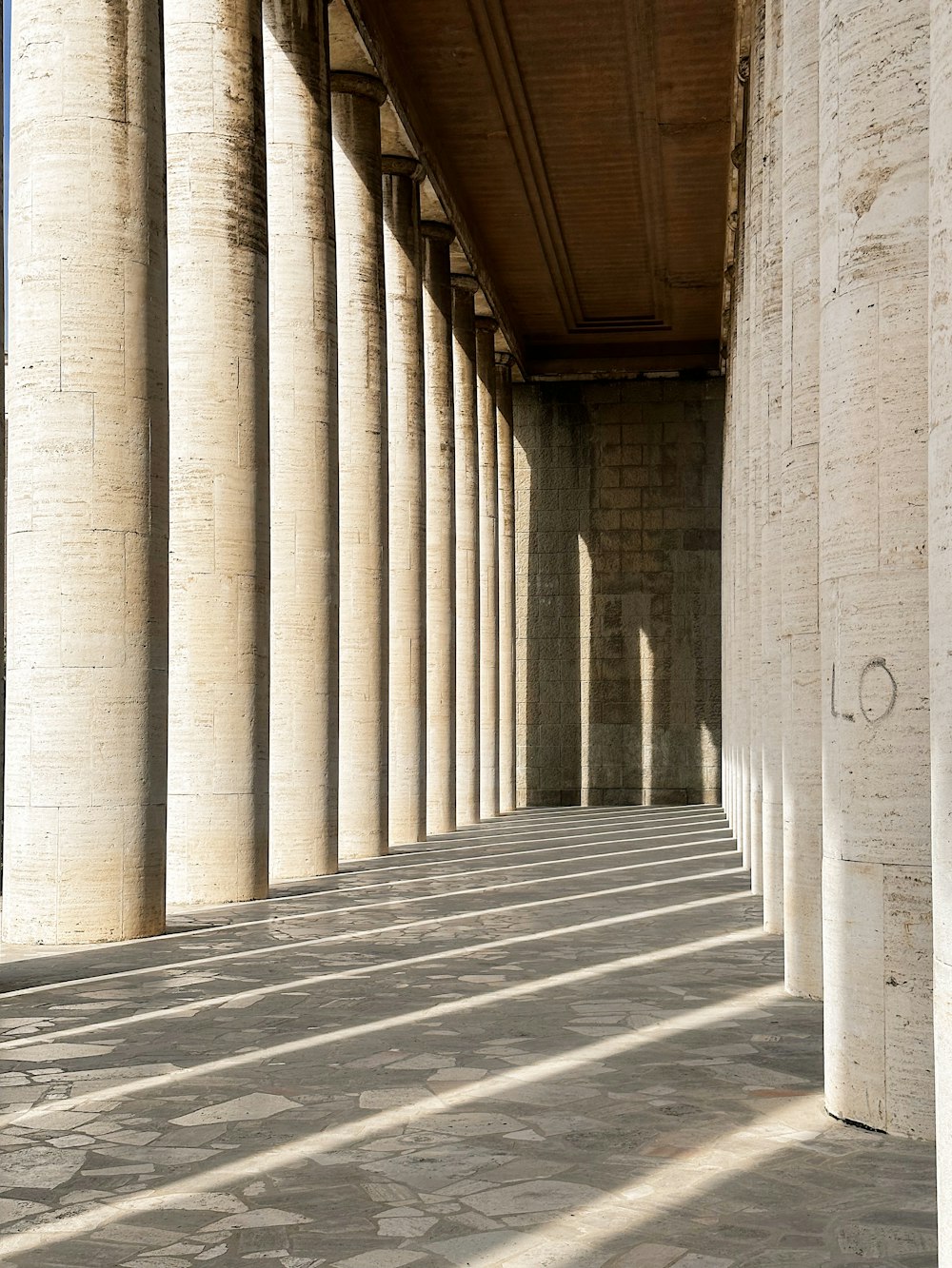 a row of columns with a sky background