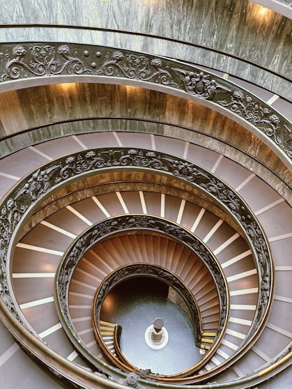 a spiral staircase in a building with a skylight