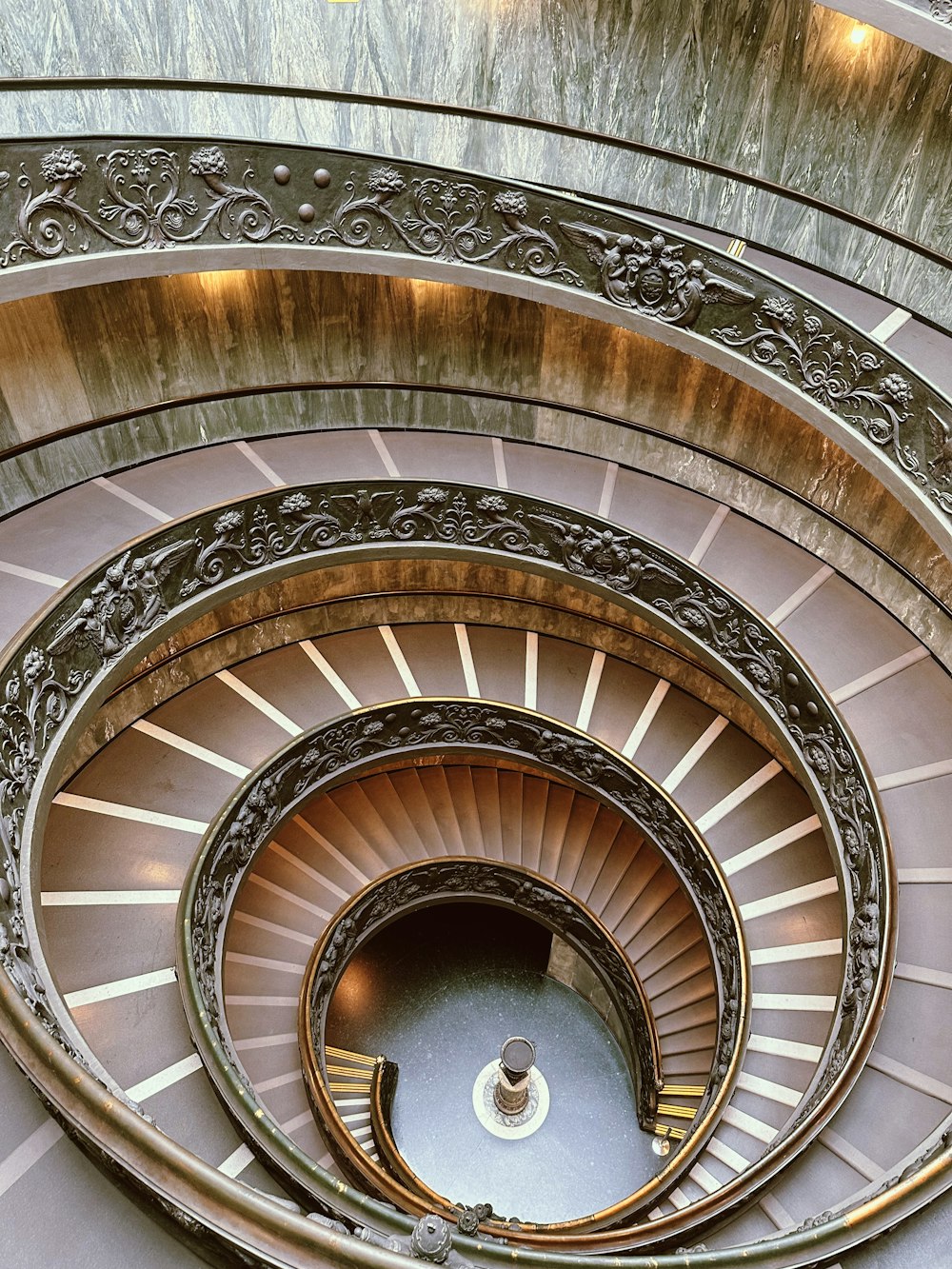 a spiral staircase in a building with a skylight